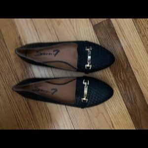 Black flats with gold buckles
